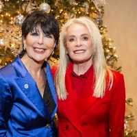 President Mantella posing with a women in front of Christmas tree